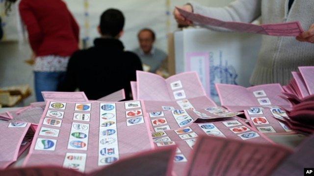 Voting officials count ballots in a polling station, Rome, Feb. 25, 2013.