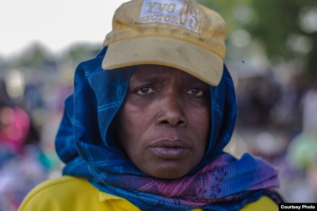 Hajja Hauwa, one of the few females in the vigilante group in Maiduguri, is in charge of security checks for women coming into Monday market, Maiduguri. (Fati Abubakar)