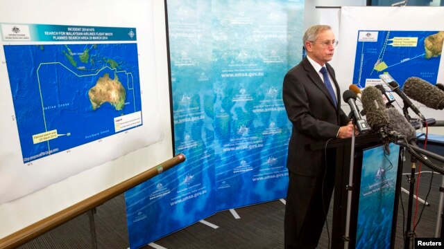 John Young, general manager of the emergency response division of the Australian Maritime Safety Authority (AMSA), answers a question as he stands in front of a diagram showing the search area for Malaysia Airlines Flight MH370 in the southern Indian Ocea