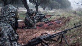 Syrian rebels fighting against President Bashar al-Assad's government take up positions near the town of Taftanaz, January 6, 2013.