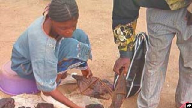 Vendor sells bats and other bush meat in market outside Yaounde, Cameroon
