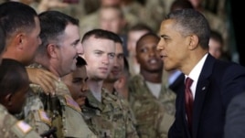President Barack Obama (R) greets members of the military before speaking at Fort Bliss, Texas, August 31, 2012.