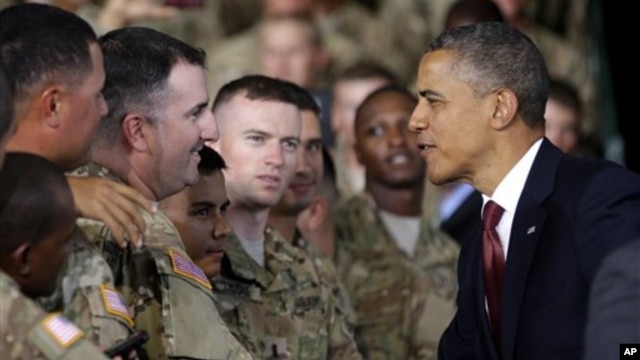 President Barack Obama (R) greets members of the military before speaking at Fort Bliss, Texas, August 31, 2012.