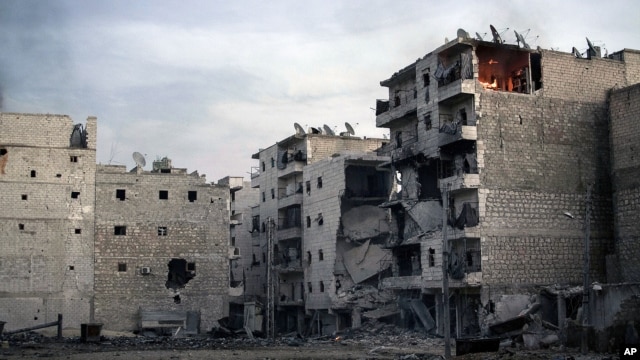 A fire is seen inside an apartment (R) of a damaged building due to heavy fighting between Free Syrian Army fighters and government forces in Aleppo, Syria, December 5, 2012.