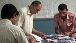 Egyptian election workers count the ballots following the end of the two day presidential election at a school in Cairo, Egypt. Experts say the elections were fairly clean given Egypt's past corruption.