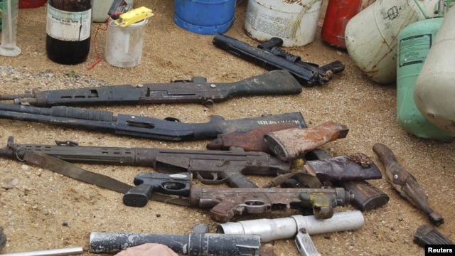 Confiscated weapons are displayed after a military raid on a hideout of suspected Islamist Boko Haram members in Nigeria's northern city of Kano August 11, 2012.