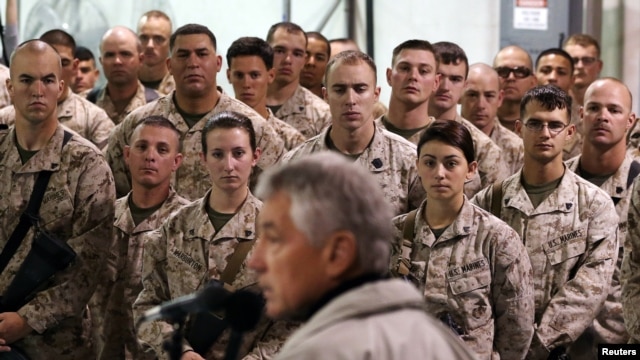 FILE -U.S. troops listen to U.S. Defense Secretary Chuck Hagel as he speaks at Camp Bastion, Helmand Province, December 8, 2013. 