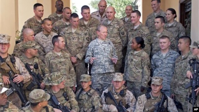 In this image released by the U.S. Department of Defense and taken Monday, Aug. 20, 2012, Army Gen. Martin E. Dempsey, chairman of the Joint Chiefs of Staff, talks to American service members with International Security Assistance Forces in Kabul, Afghani