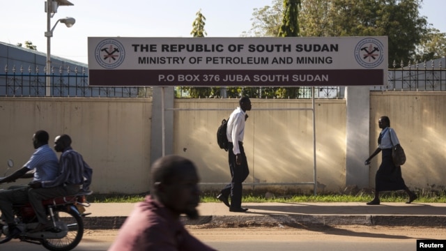People pass by the Ministry of Petroleum and Mining in Juba, November 7, 2012. 