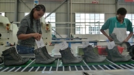 People work on the assembly line at a shoe factory in Dukem, Ethiopia, April 19, 2012.