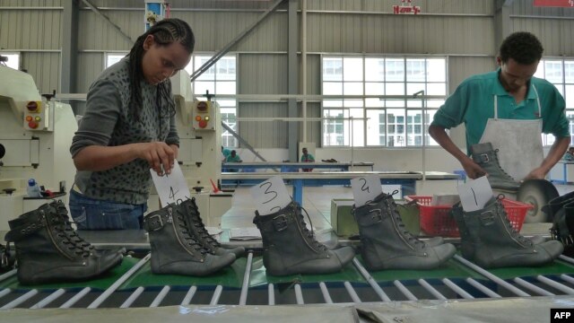 People work on the assembly line at a shoe factory in Dukem, Ethiopia, April 19, 2012.