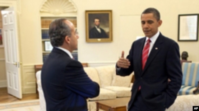 President Barack Obama and President Felipe Calderón of Mexico confer in the Oval Office, before their joint press conference in the Rose Garden of the White House, May 19, 2010