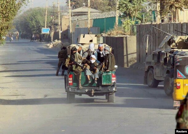 Afghan Local Police (ALP) forces sit on the back of a police pickup in Kunduz city, Afghanistan, Oct. 4, 2016.