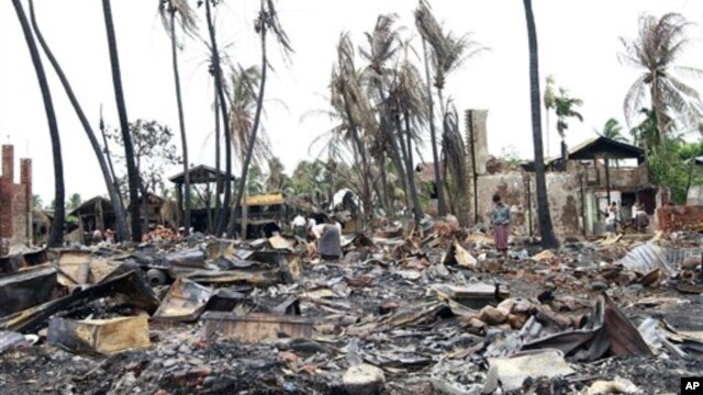 People shift through damaged buildings in Sittwe, capital of Rakhine state, western Burma, June 16, 2012.