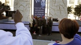 People take a picture of a group with the Martin Luther King float prepared for the 57th Presidential Inaugural Parade in Washington, January 20, 2013.