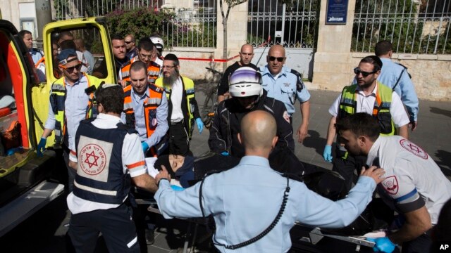 Israeli medics move a Palestinian woman, who police believe attacked a man, at the scene of a stabbing attack in Jerusalem, Nov. 23, 2015.