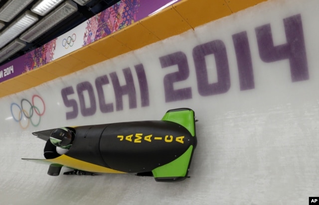 The JAM-1 sled from Jamaica, takes a turn during a training run for the men's two-man bobsled at the 2014 Winter Olympics, Feb. 6, 2014, in Krasnaya Polyana, Russia.
