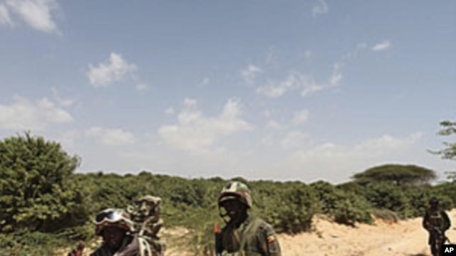 Ugandan peacekeepers from the African Union Mission in Somalia (AMISOM) patrol a road following an encounter with Islamist militia in the northern suburbs of Somalia's capital Mogadishu, January 20, 2012.