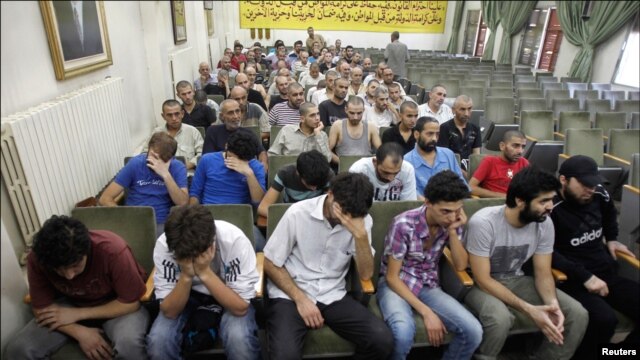 Demonstrators hold opposition flags during a protest against Syria's President Bashar al-Assad at Kfr Suseh area in Damascus July 10, 2012. 
