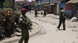 Kenyan police guard the scene following an explosion at a church in Nairobi, Kenya, September 30, 2012.