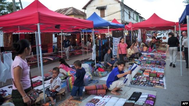 Handicraft and souvenir vendors wait for customers and tourists at the night market of Luang Prabang, October 18, 2009.