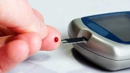 Testing blood sugar at home with a blood glucose meter.