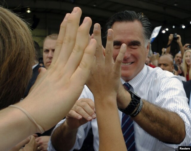 Republican presidential nominee Mitt Romney greets audience members at a campaign rally at the airport in Sanford, Florida, November 5, 2012.