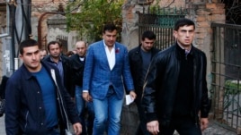 Georgia's outgoing President Mikheil Saakashvili (C) is seen heading to a polling station in Tbilisi October 27, 2013.
