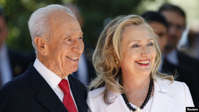 Israel's President Shimon Peres stands with U.S. Secretary of State Hillary Clinton before their meeting in Jerusalem, July 16, 2012