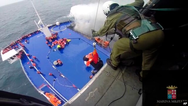 Một phụ nữ được kéo lên trực thăng từ chiếc phà bị cháy ở biển Adriatic, ngày 28/12/2014.