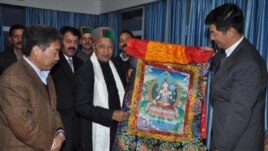 Sikyong Dr Lobsang Sangay (Right) presenting a Tibetan thangka painting to shri Virbhadra Singh (C). Sikyong is accompanied by Kalon Tsering Dhondup (left).