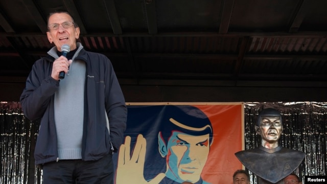 FILE - With a likeness of his Vulcan character, Mr. Spock, in the background, Leonard Nimoy speaks to the residents of the town of Vulcan, Alberta, April 23, 2010.