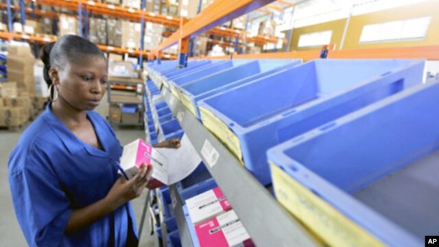 A worker looks at the stock of medicine in the Pharmacie de la Sante Publique (Public Health Medicine) warehouse in Abidjan, March 17, 2011