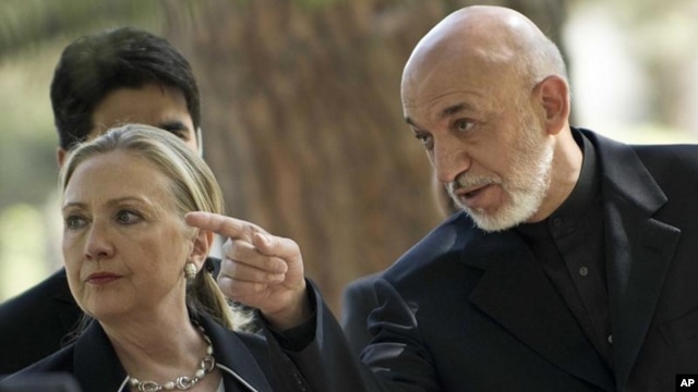 US Secretary of State Hillary Rodham Clinton, left, walks with President of Afghanistan Hamid Karzai to a press conference at the Presidential Palace in Kabul Saturday July 7, 2012.