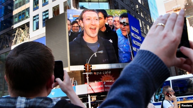 FILE - Facebook Inc. CEO Mark Zuckerberg is seen on a screen televised in New York from the company's headquarters in Menlo Park, California.