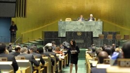 A U.N. conference officer distributes ballots to delegations as the UN General Assembly prepares to elect five new non-permanent members of the UN Security Council, Oct 18, 2012.
