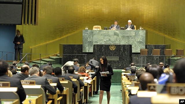 A U.N. conference officer distributes ballots to delegations as the UN General Assembly prepares to elect five new non-permanent members of the UN Security Council, Oct 18, 2012.