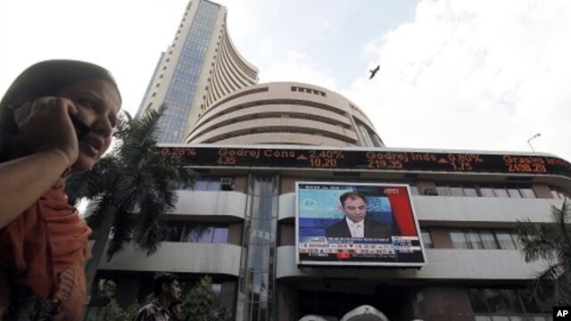 A woman speaks on her phone as she walks past the Bombay Stock Exchange (BSE) building in Mumbai (File Photo)