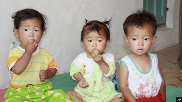 Children eat bread at a nursery in Myongchon County, North Hamgyong province in this handout picture (File)