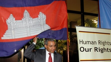 U.N. special rapporteur Surya Subedi walks through a Cambodian national flag upon his arrival in a conference room of U.N. headquarter in Phnom Penh, Cambodia in 2010.