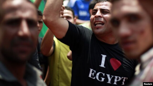 Protesters take part in a demonstration at Tahrir Square in Cairo June 15, 2012.