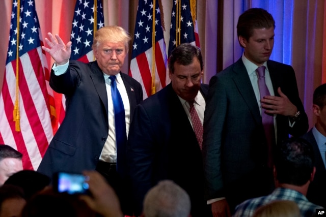 Republican presidential candidate Donald Trump, accompanied by New Jersey Gov. Chris Christie, center, and his son Eric Trump, right, depart after speaking during a news conference on Super Tuesday primary election night in the White and Gold Ballroom at