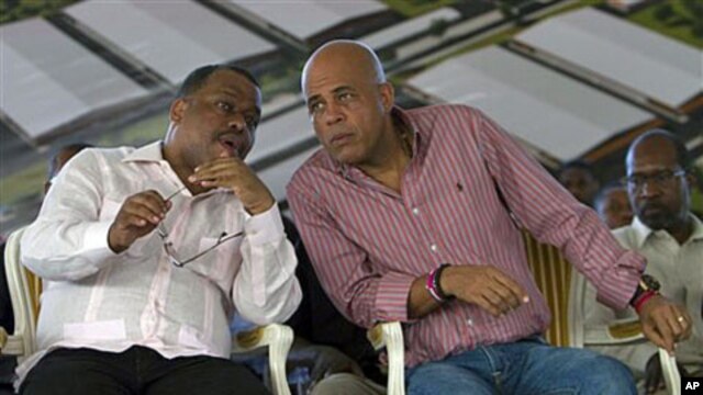 Haiti's President Michel Martelly (R) speaks with Haiti's Prime Minister Garry Conille at a ceremony on the outskirts of Cap Haitien, Haiti, November 28, 2011.