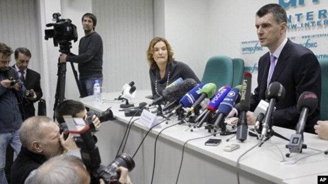 Mikhail Prokhorov, right, one of Russia's richest tycoons and New Jersey Nets basketball team owner, speaks at a press conference in Moscow, to announces his candidacy to run against Russian PM Vladimir Putin in the March 2012 presidential election, Decem