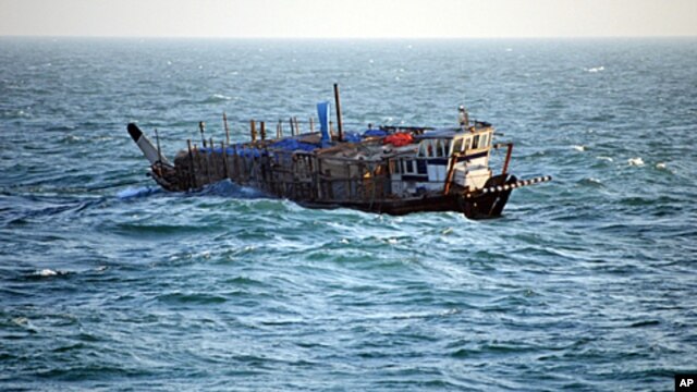 In this photo provided by the U.S. Navy, the Iran-flagged, Ya-Hussayn, takes on water in the Persian Gulf, January 10, 2012.