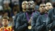 Lebron James (C) of the U.S. and teammates listen to the national anthem during victory ceremony at the North Greenwich Arena during the London 2012 Olympic Games August 12, 2012. 