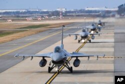 In this photo provided by the South Korea Defense Ministry, South Korean Air Forces' KF-16 fighters prepare to take off during a joint aerial drills called Vigilant Storm between U.S and South Korea, in Gunsan, South Korea, Monday, Oct. 31, 2022. (South Korea Defense Ministry via AP)