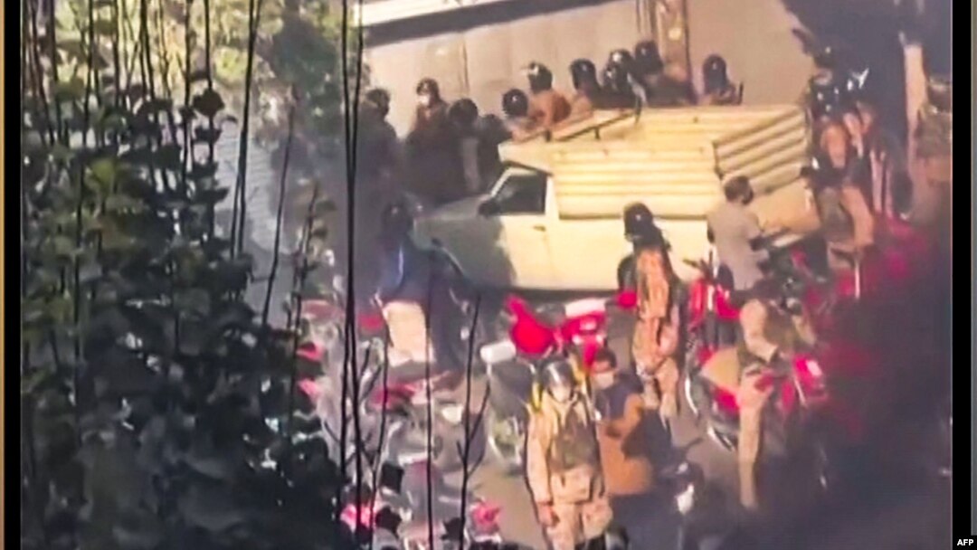 This image grab from a UGC video posted on Nov. 1, 2022, reportedly shows security forces trying to enter a closed shopping center on Amir Kabir street in Iran's capital Tehran before being engulfed by gas matter. 