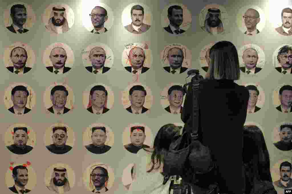 A wall showing doodle marks on portraits of various dictators is seen during the Oslo Freedom Forum in Taipei, Taiwan.