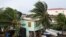 Palm trees are buffeted by strong winds before the arrival of Hurricane Lisa in Belize City on Nov. 2, 2022.